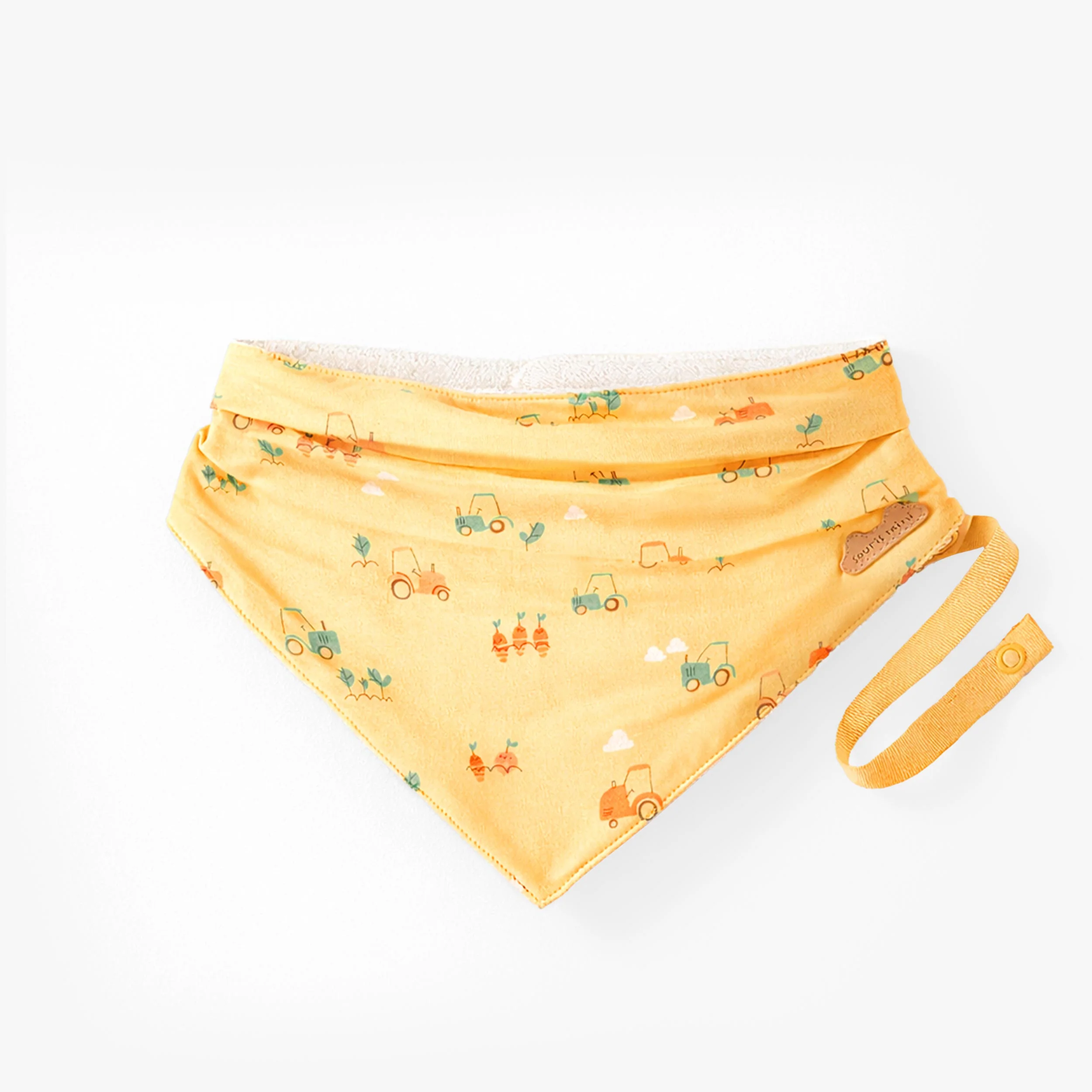 Bavoir jaune à motifs, naissance