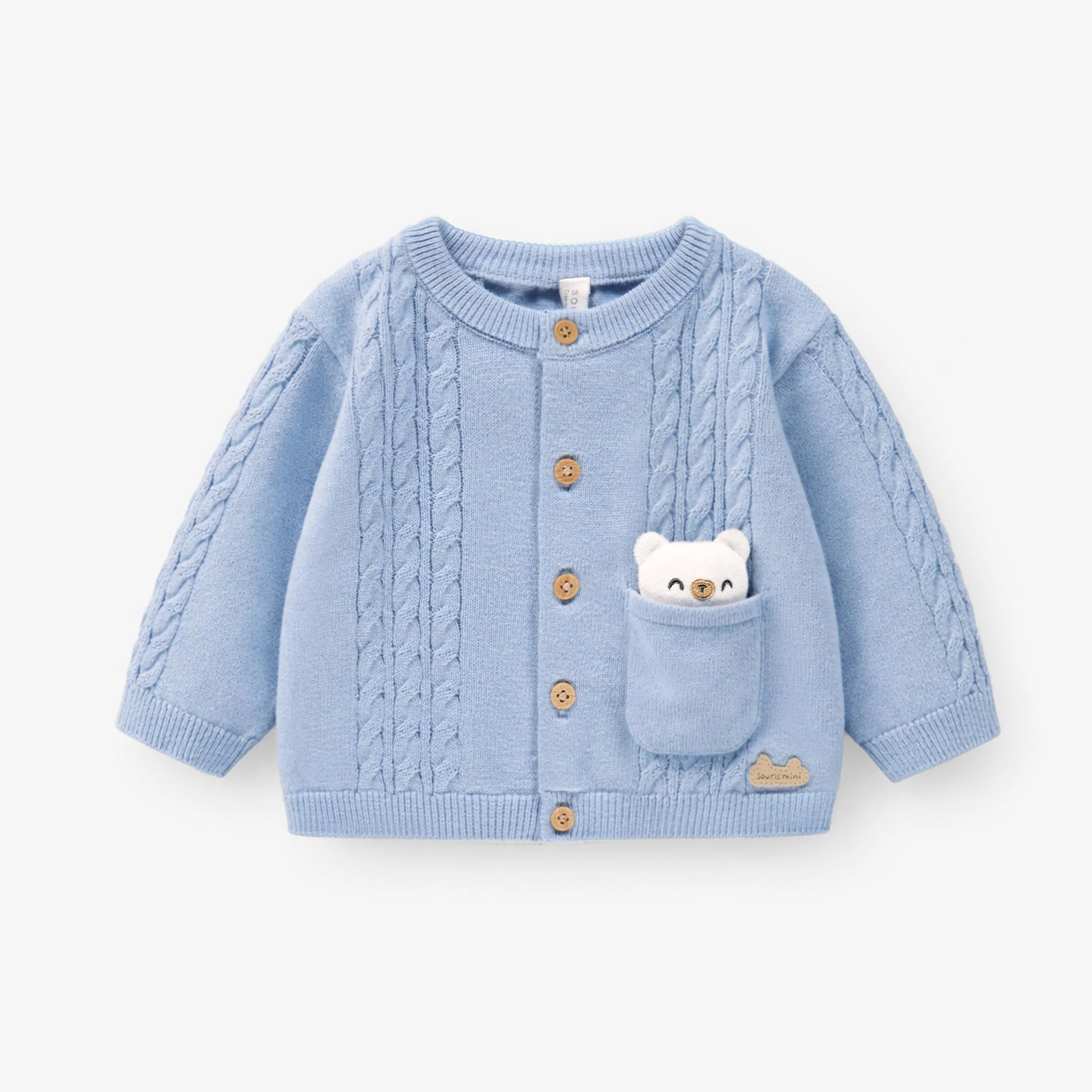 Cardigan bleu en tricot, naissance