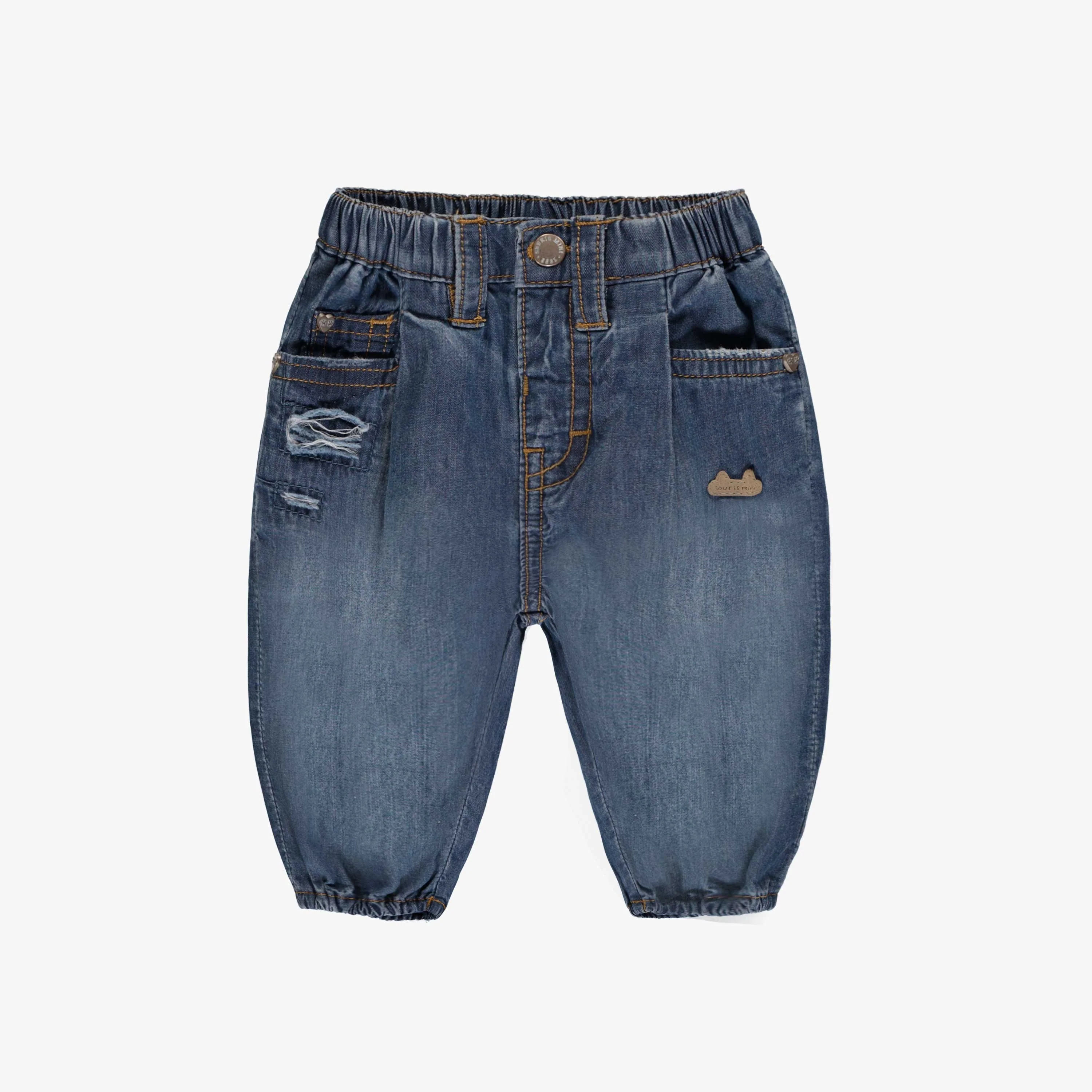 Jean bleu au look usé, naissance