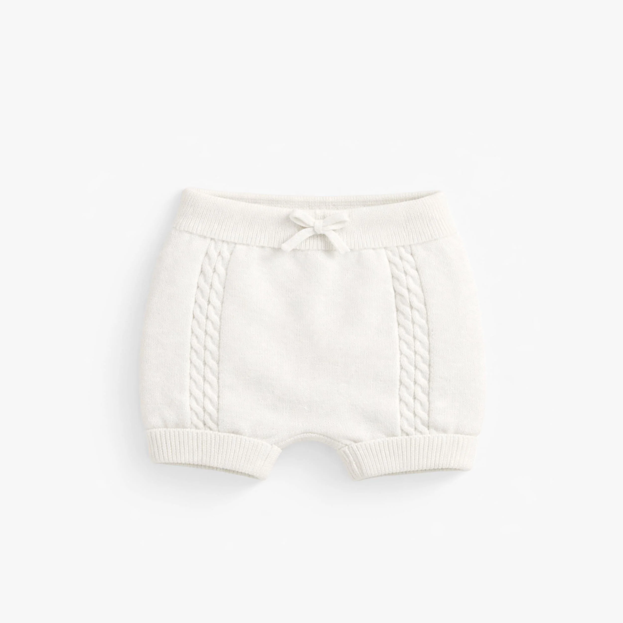 Short crème en tricot, naissance